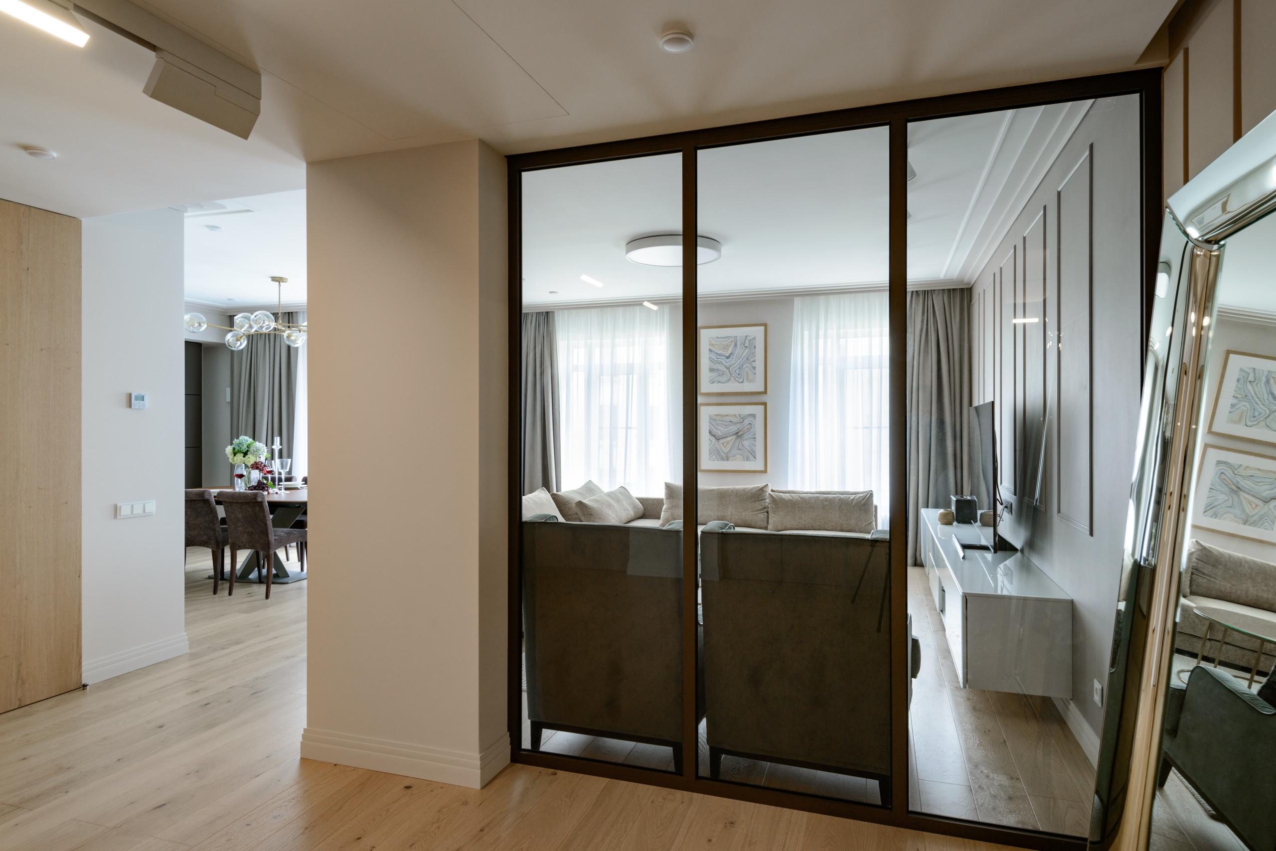 Интерьер гостиной с перегородкой раздвижной и зеркалом на двери в современном стиле