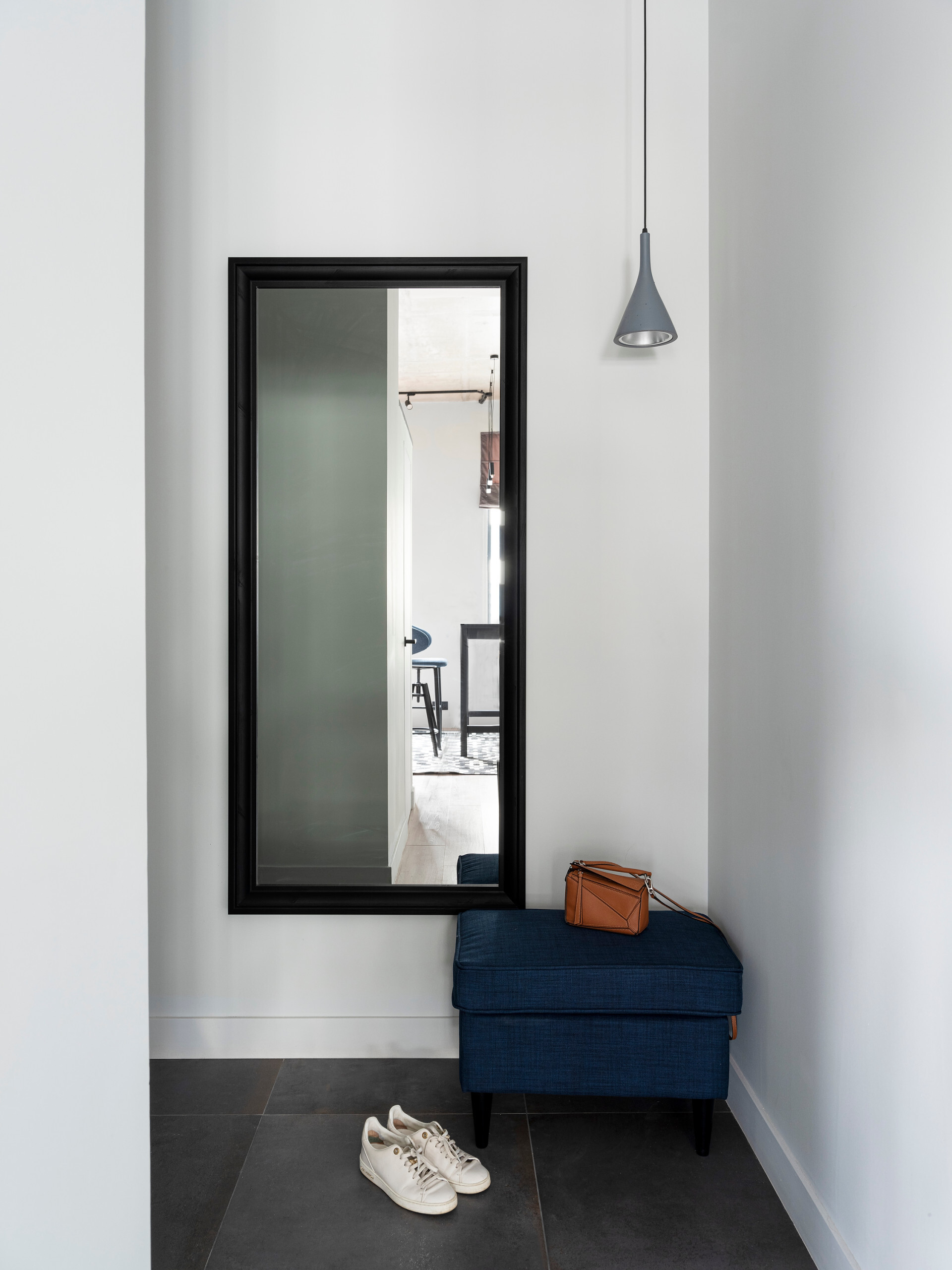 Интерьер прихожей с полом и стены одного цвета, проходной и зеркалом на двери в современном стиле